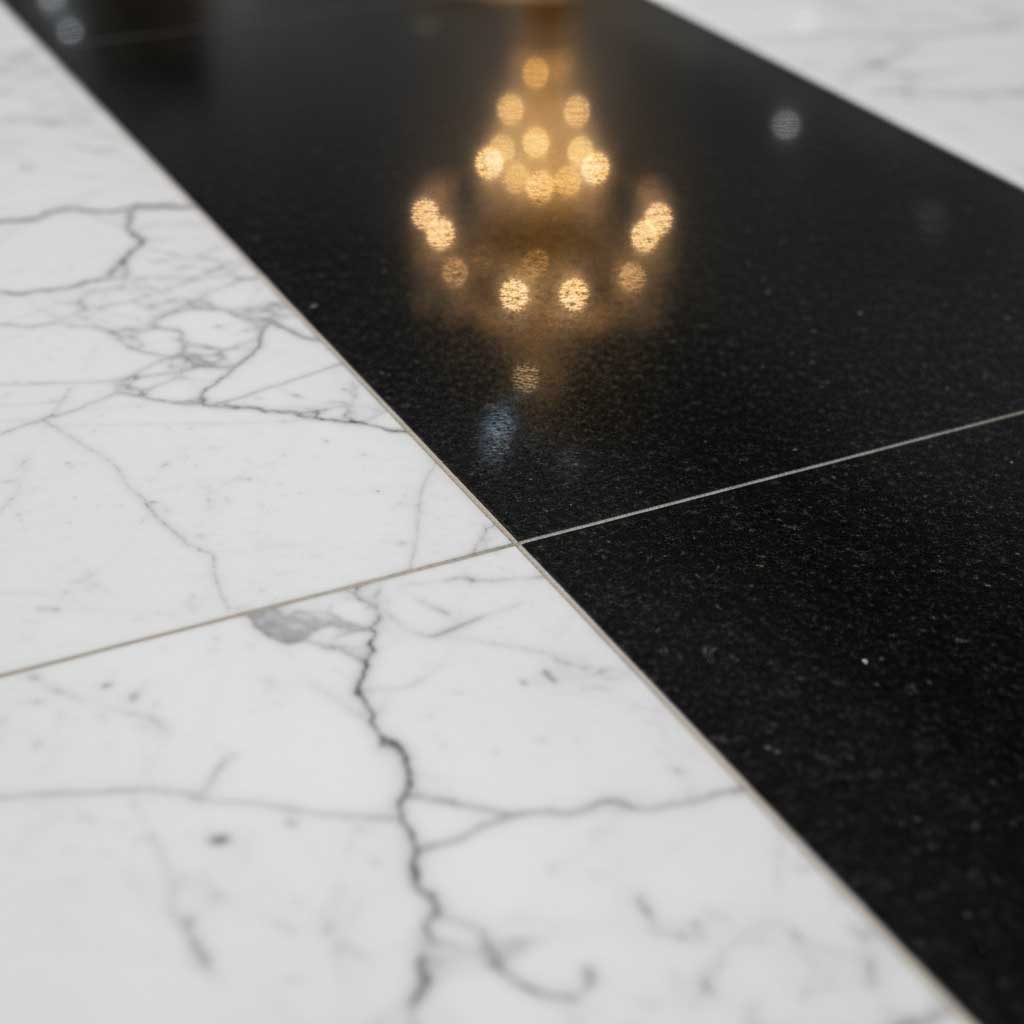 Extreme close-up Calacatta marble black granite flooring Fashion Avenue raking light texture